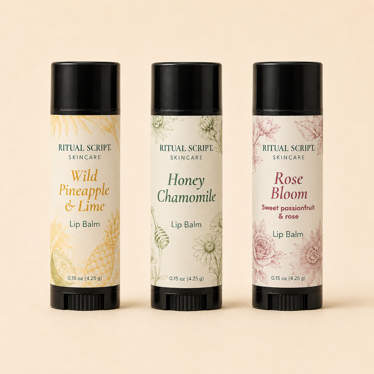 Three Ritual Lip Balm tubes standing side by side — Wild Pineapple & Lime, Honey Chamomile, and Rose Bloom — in cream botanical labels with black caps