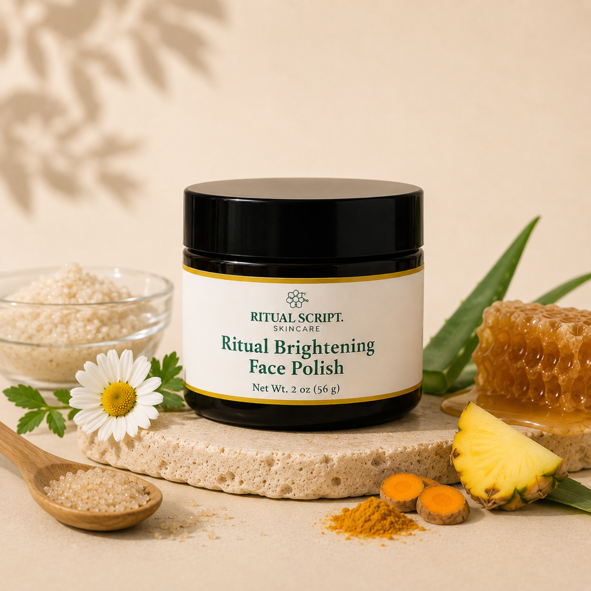 Ritual Brightening Face Polish styled with chamomile, honey, turmeric, and pineapple on a stone surface