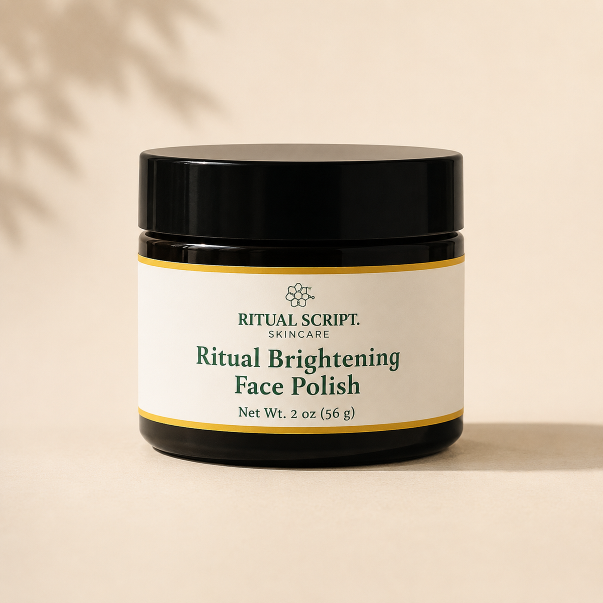 Ritual Brightening Face Polish in a 2 oz black glass jar with a gold-rimmed cream label