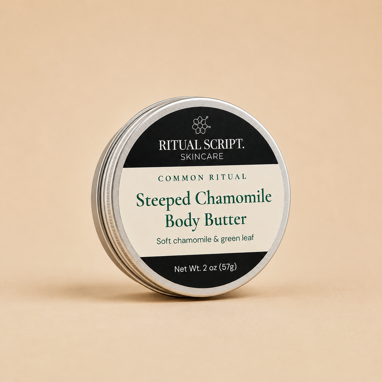 Steeped Chamomile Body Butter in a 2 oz silver tin with a cream and black label reading soft chamomile and green leaf