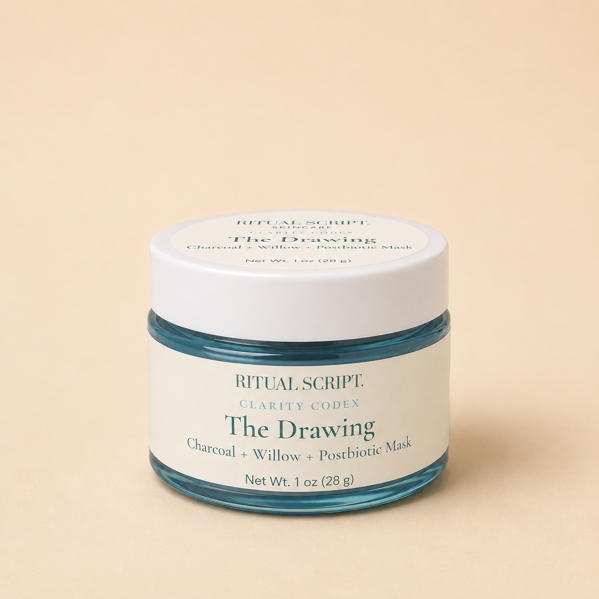 The Drawing charcoal mask in a 1 oz teal glass jar with a cream lid and label reading charcoal, willow, and postbiotic mask