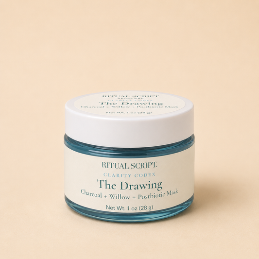 The Drawing charcoal mask in a 1 oz teal glass jar with a cream lid and label reading charcoal, willow, and postbiotic mask