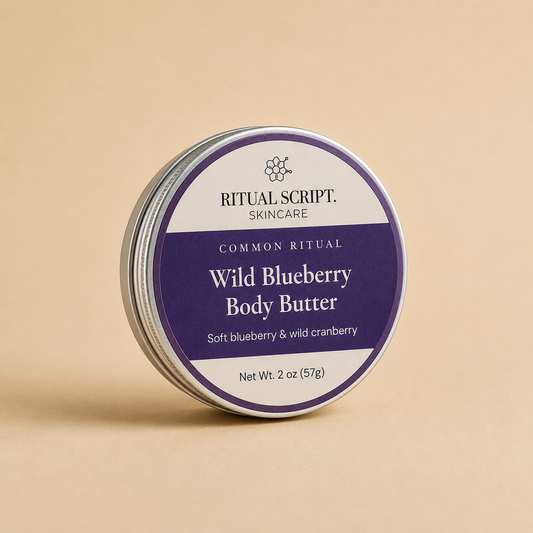 Wild Blueberry Body Butter in a 2 oz purple tin with a cream and violet label reading soft blueberry and wild cranberry