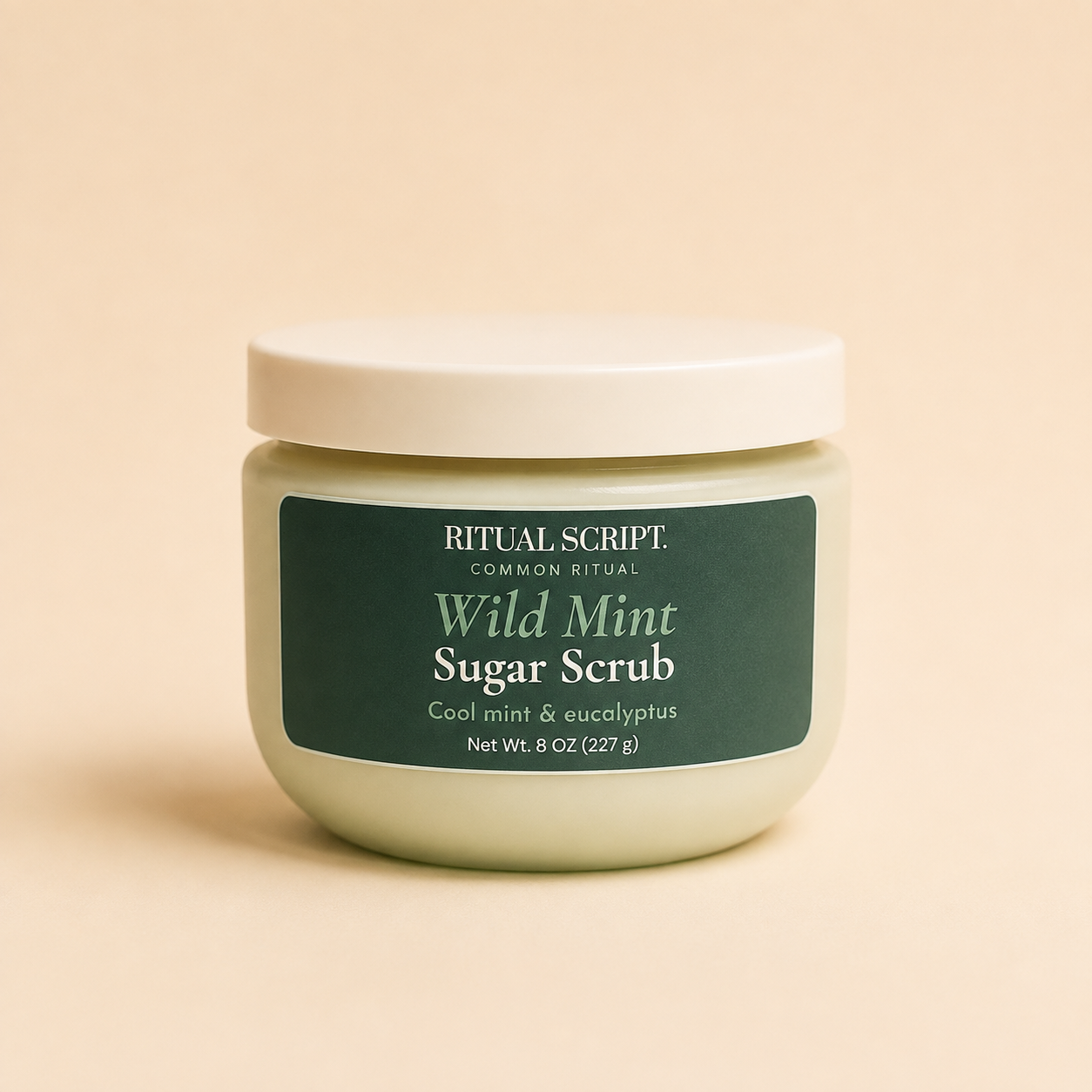 Wild Mint Sugar Body Scrub in an 8 oz pale green jar with a cream lid and forest green label reading cool mint and eucalyptus